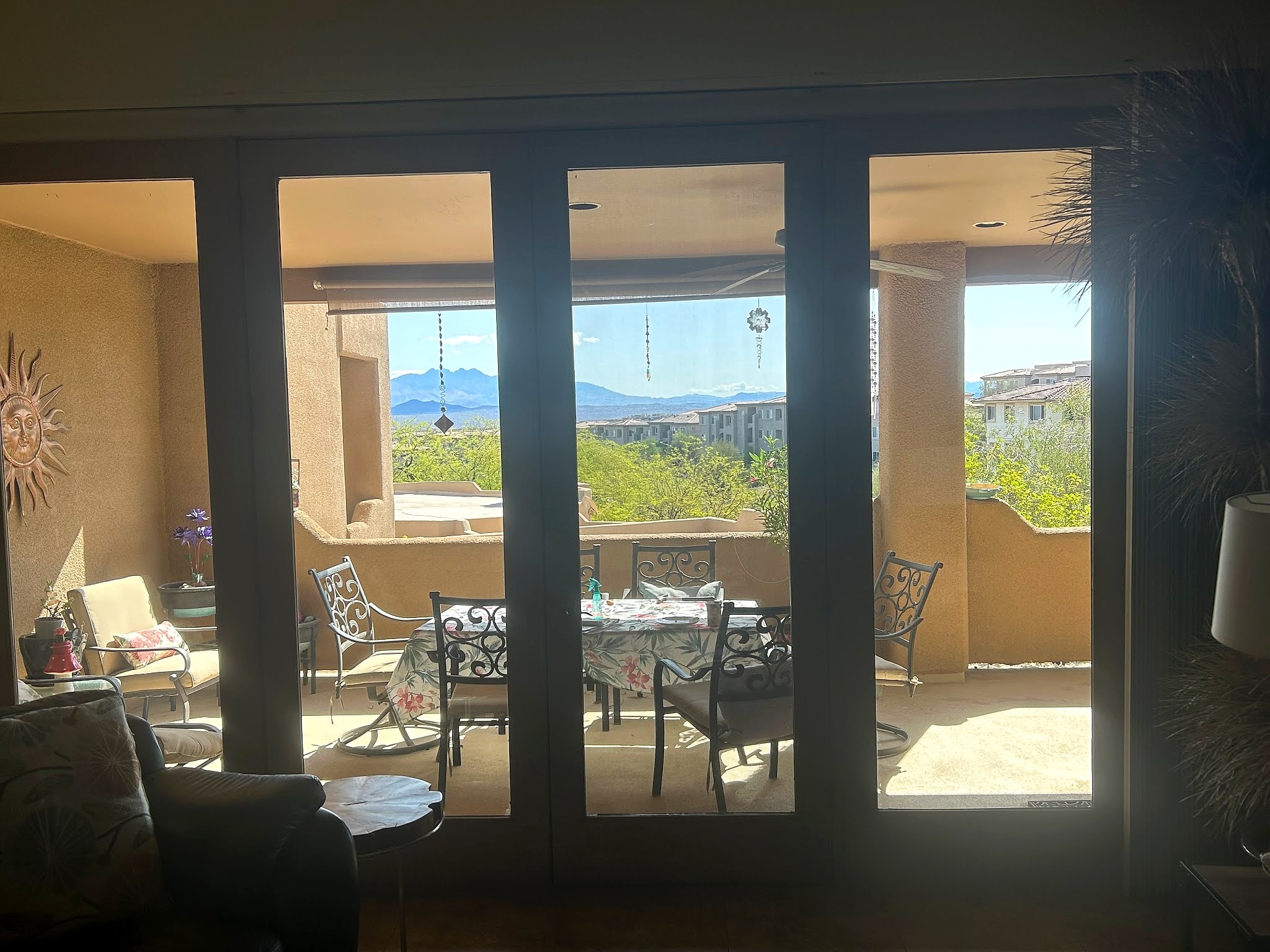 Living room glass doors opening onto a patio and mountain view