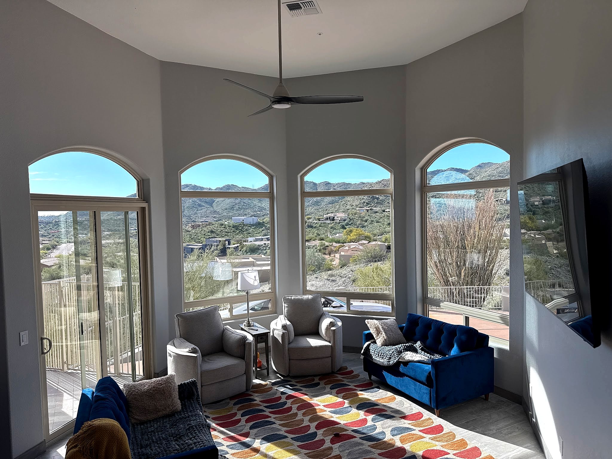 Great room with arched windows and a mountain view